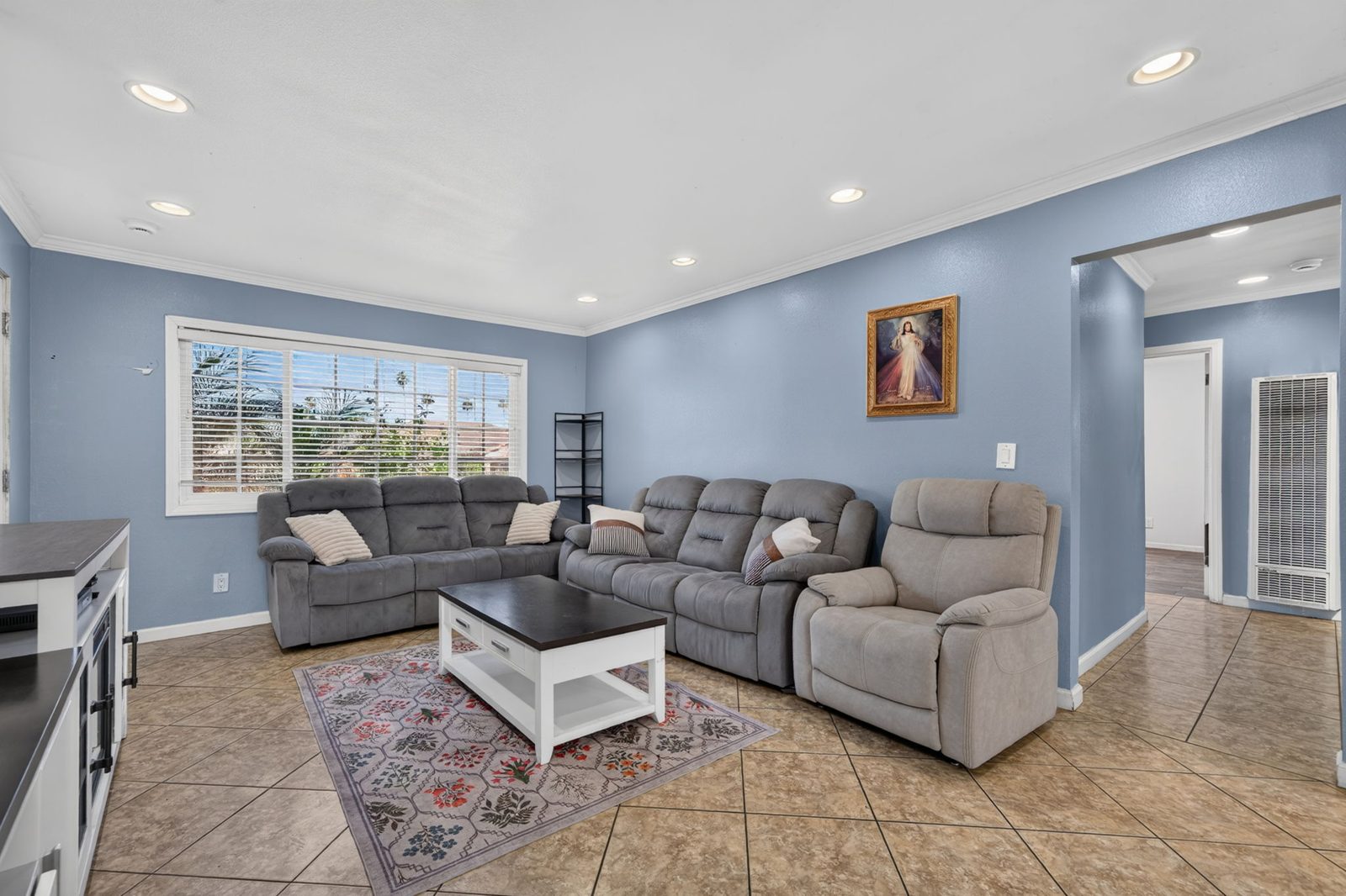 Open living room with recessed lighting and tile floors
