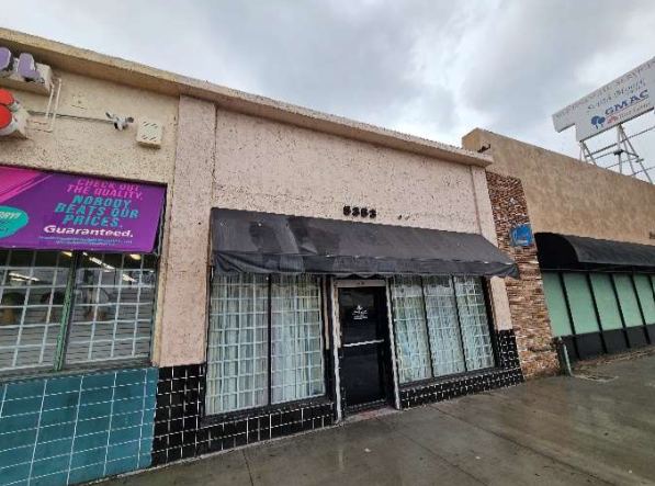 The 5353 Crenshaw storefront with a black awning, empty behind the glass.